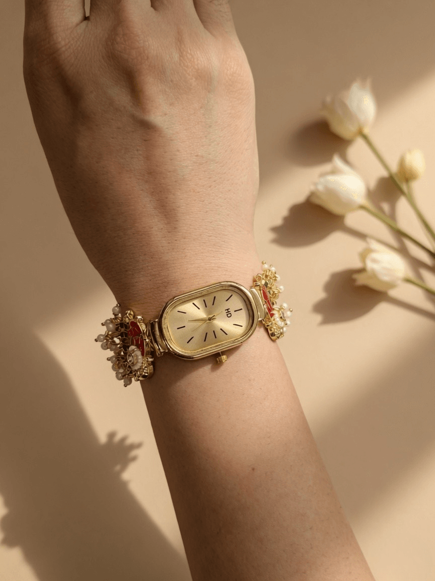 Elephant motif gold bracelet watch with red green kundan and pearls