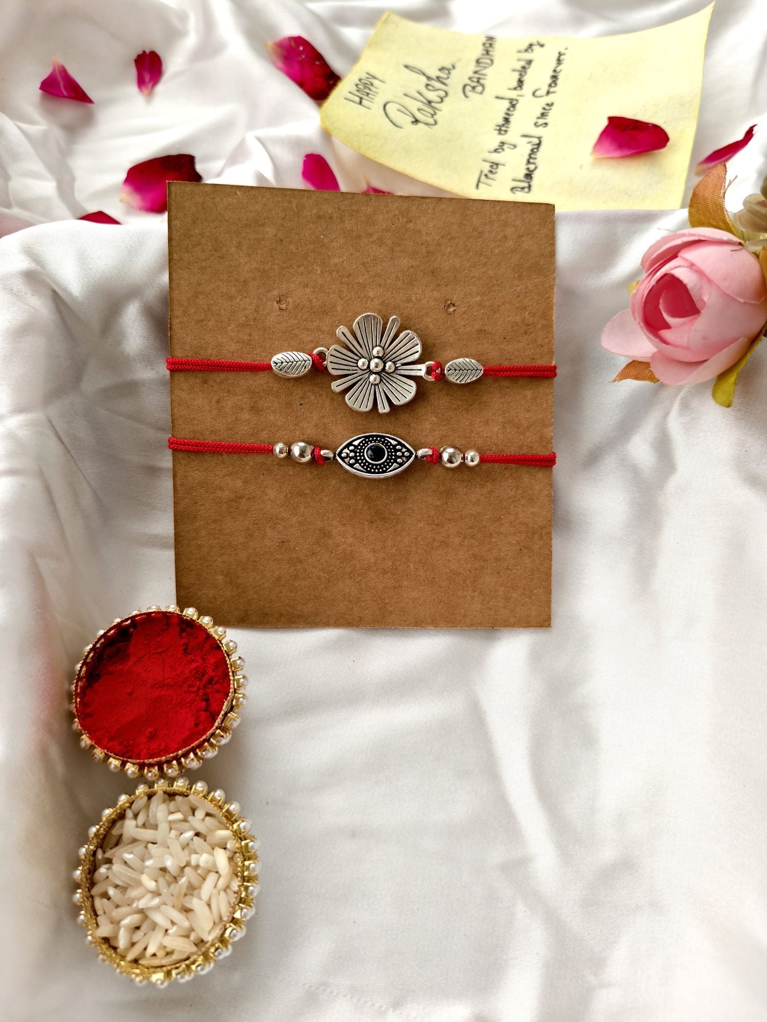 Silver evil eye rakhi hamper with Dairy Milk chocolate, roli chawal