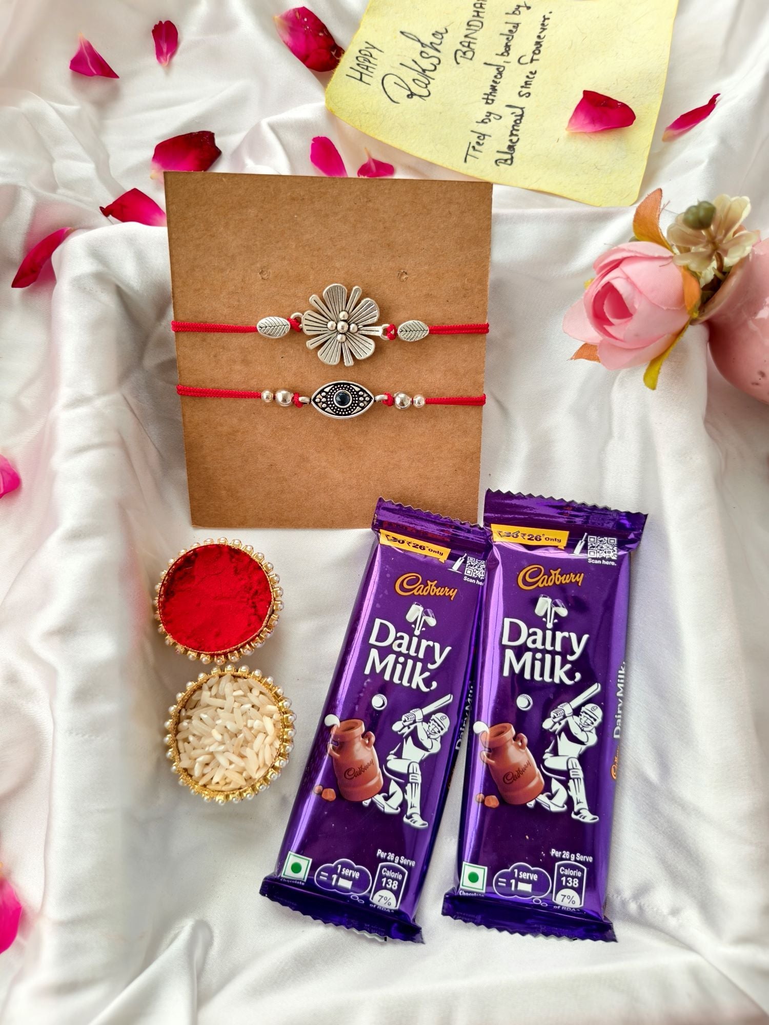 Silver evil eye rakhi hamper with Dairy Milk chocolate, roli chawal