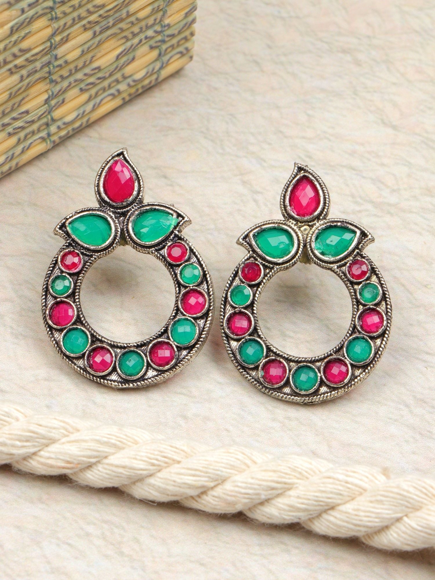 Pair of round oxidized stone earrings in red and teal, ideal for women and girls attending festivals, weddings, or parties