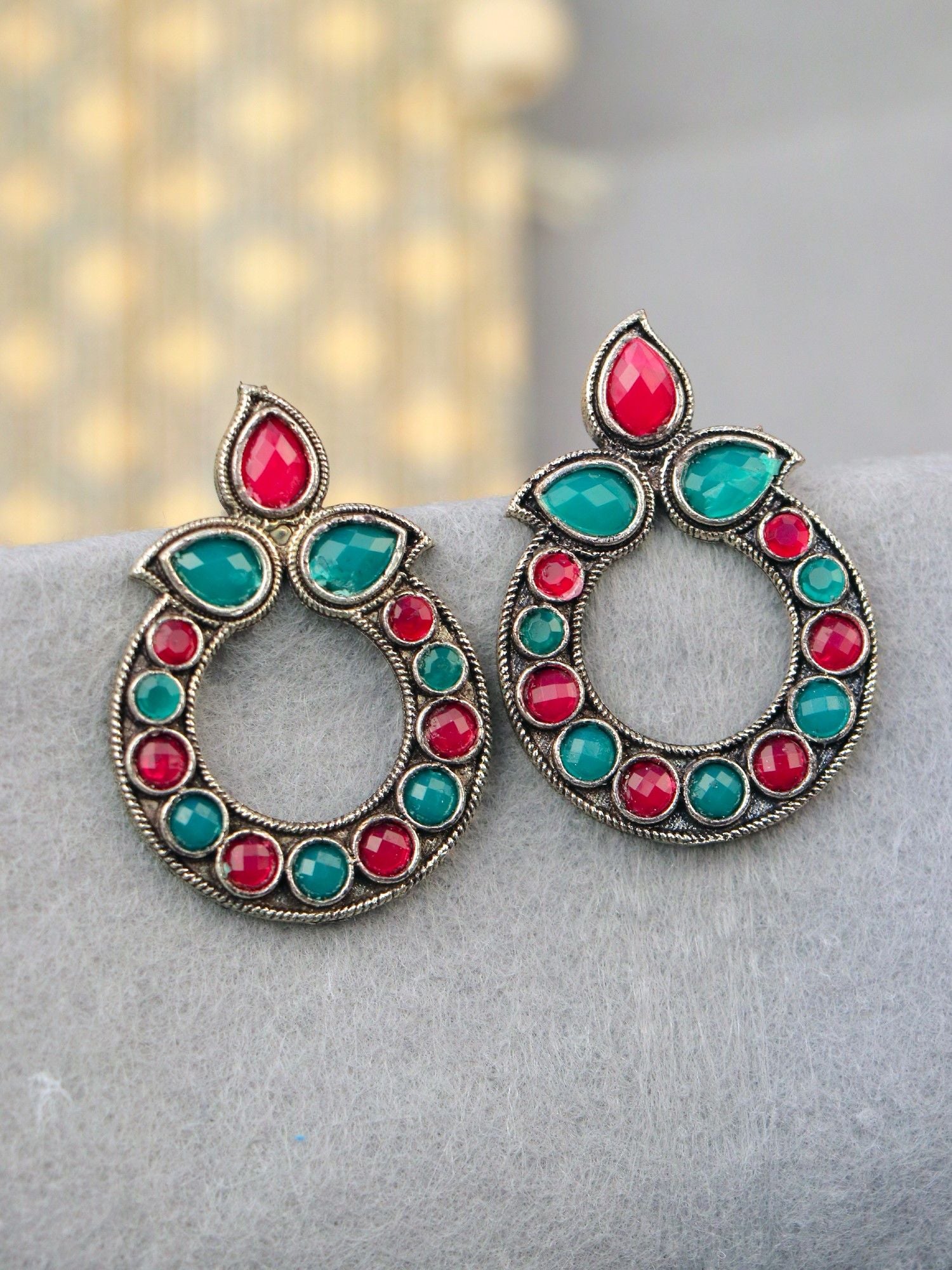 Pair of round oxidized stone earrings in red and teal, ideal for women and girls attending festivals, weddings, or parties