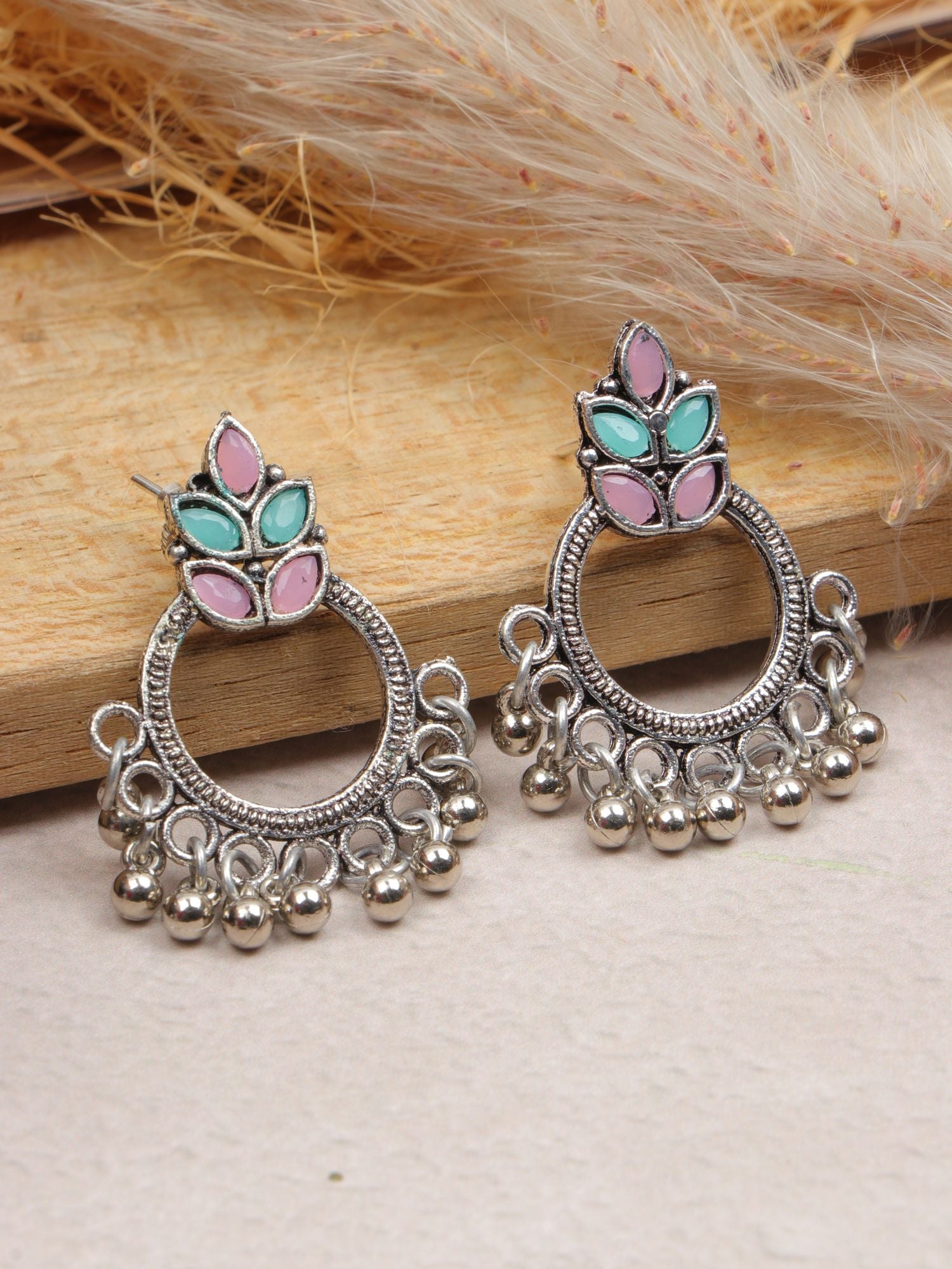 Pair of multi-colour silver oxidized round earrings in pink and sea green, ideal for parties and festivals