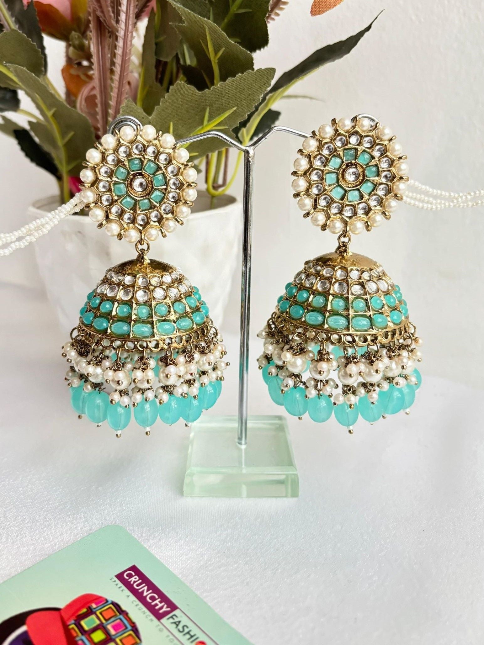Heavy sea-green Kundan pearl Jhumka earrings for women with ear chain and moti work.