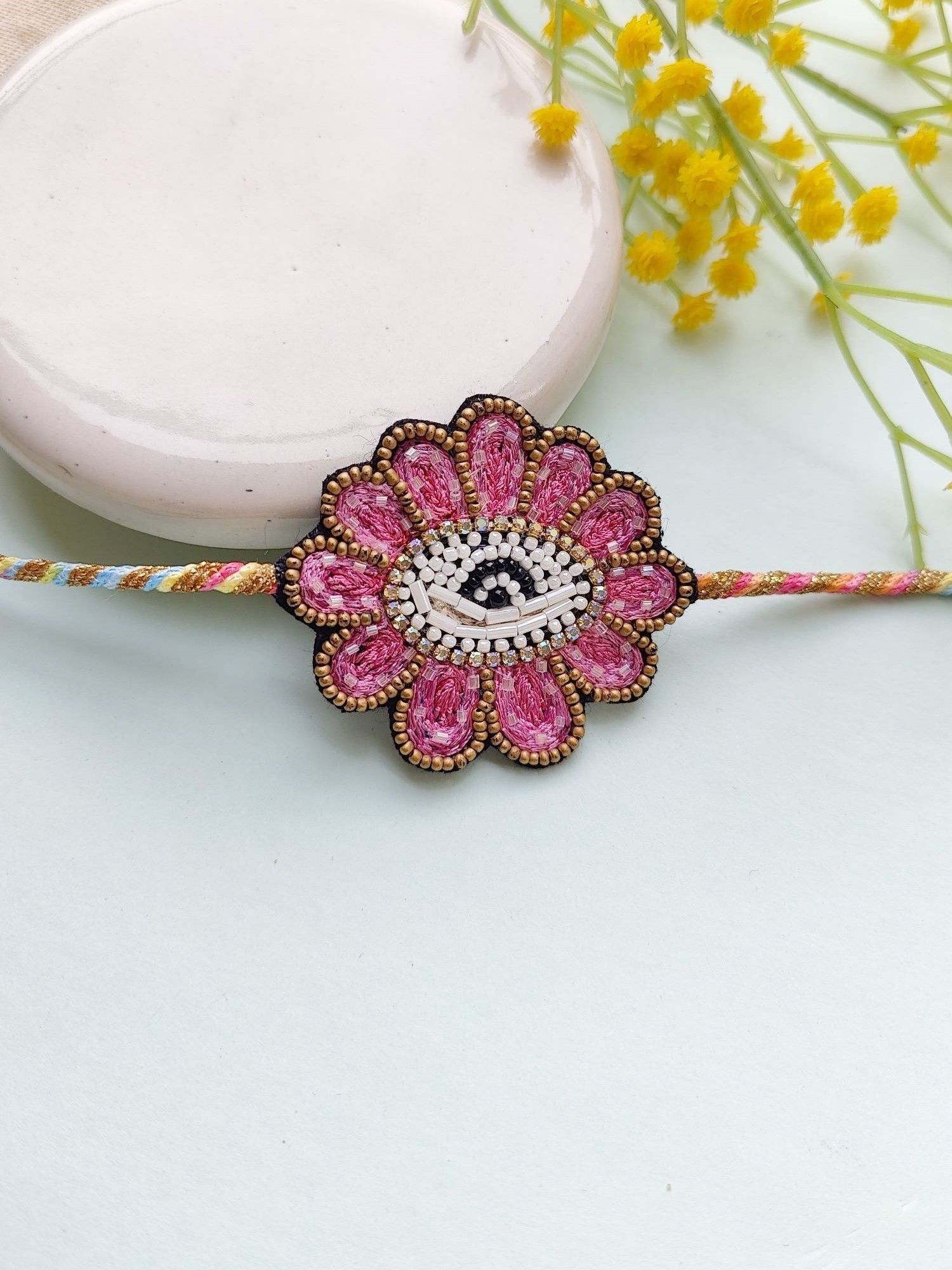 Handmade Pink Beaded Rakhi: Elegant Sibling Bond Token