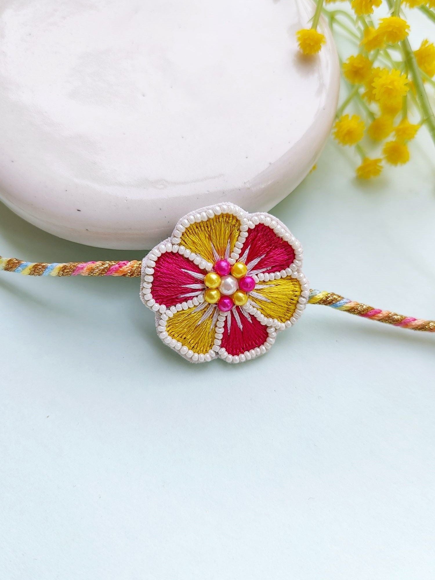 Blossom Bond: Handcrafted Pink-Yellow Beaded Rakhi 2025